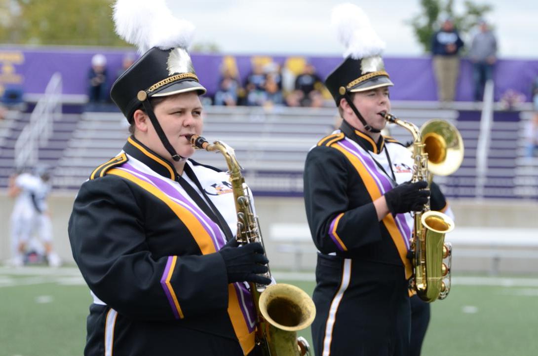 Saxophone players in AU Marching Band performing during football game